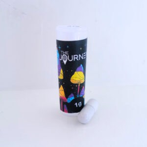 Photo of journey capsules bottle with a white capsule sitting next to it.