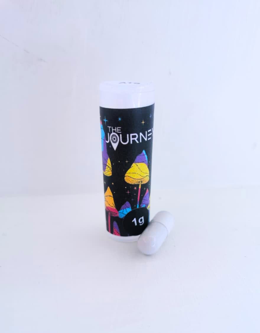 Photo of journey capsules bottle with a white capsule sitting next to it.