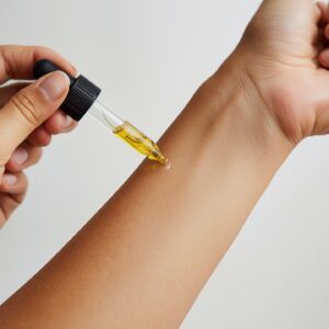 Someone using cannabis tinctures on their arm